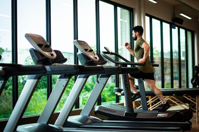 Person running on a treadmill inside a gym